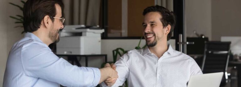 two men shaking hands during interview