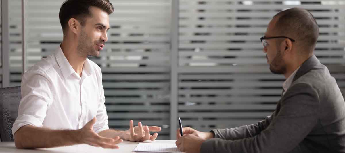 Men talking in an interview