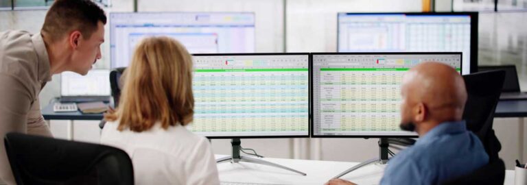 Team looking at multiple spreadsheets